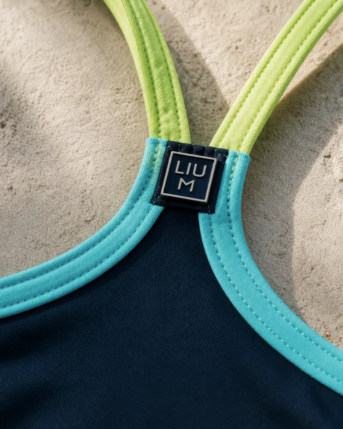 Close-up of turquoise and lime straps with a woven LIUM label